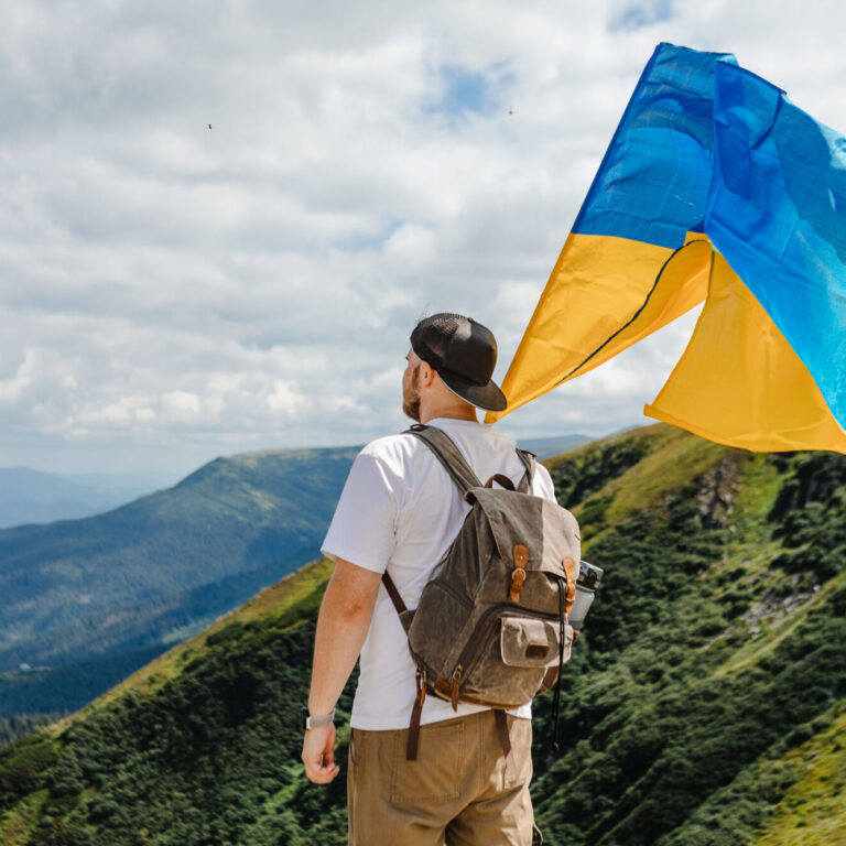 Man on Mountains with Ukrainian Flag