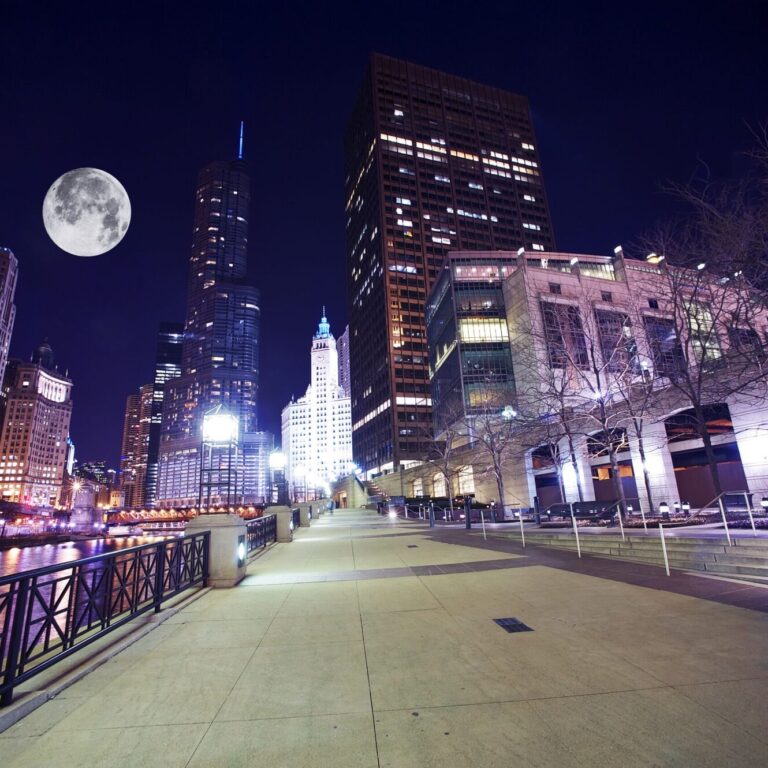 Chicago Famous Riverwalk - Chicago Riverwalk at Night. Beautiful Colorful Wide Angle Photography. Large Moon on the Sky. Chicago, Illinois, USA.