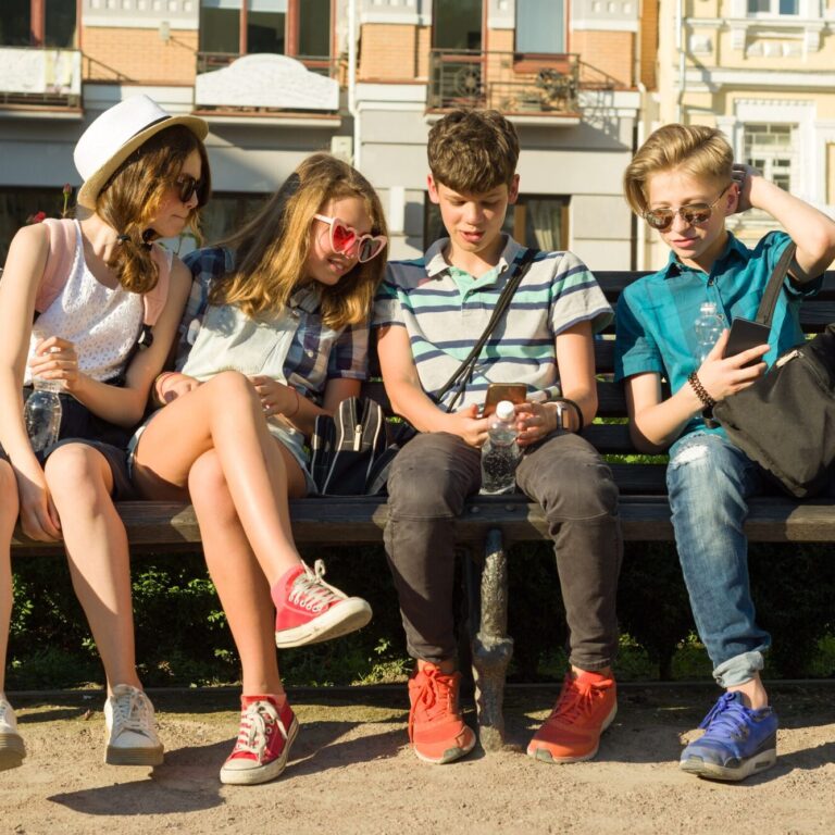 Group of youth is having fun together outdoors in urban background. Summer holidays, education, teenage concept