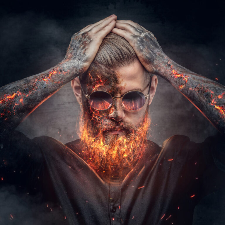 Demonic male with burning beard and arms in fire sparks.