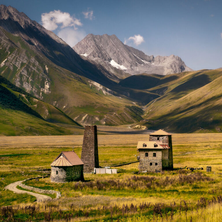 Landscape view of Caucasus mountains and stone houses and tower, Kazbegi region, Country of Georgia