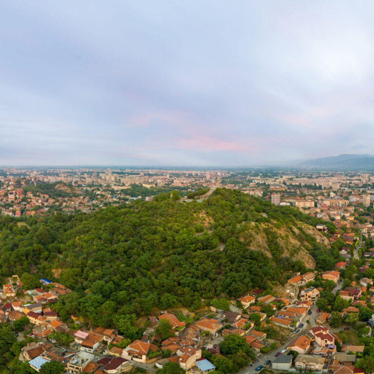 Old historical town of Plovdiv with residential buildings and churches in Bulgaria in valley of Rhodope mountains and forests. Panorama, top view